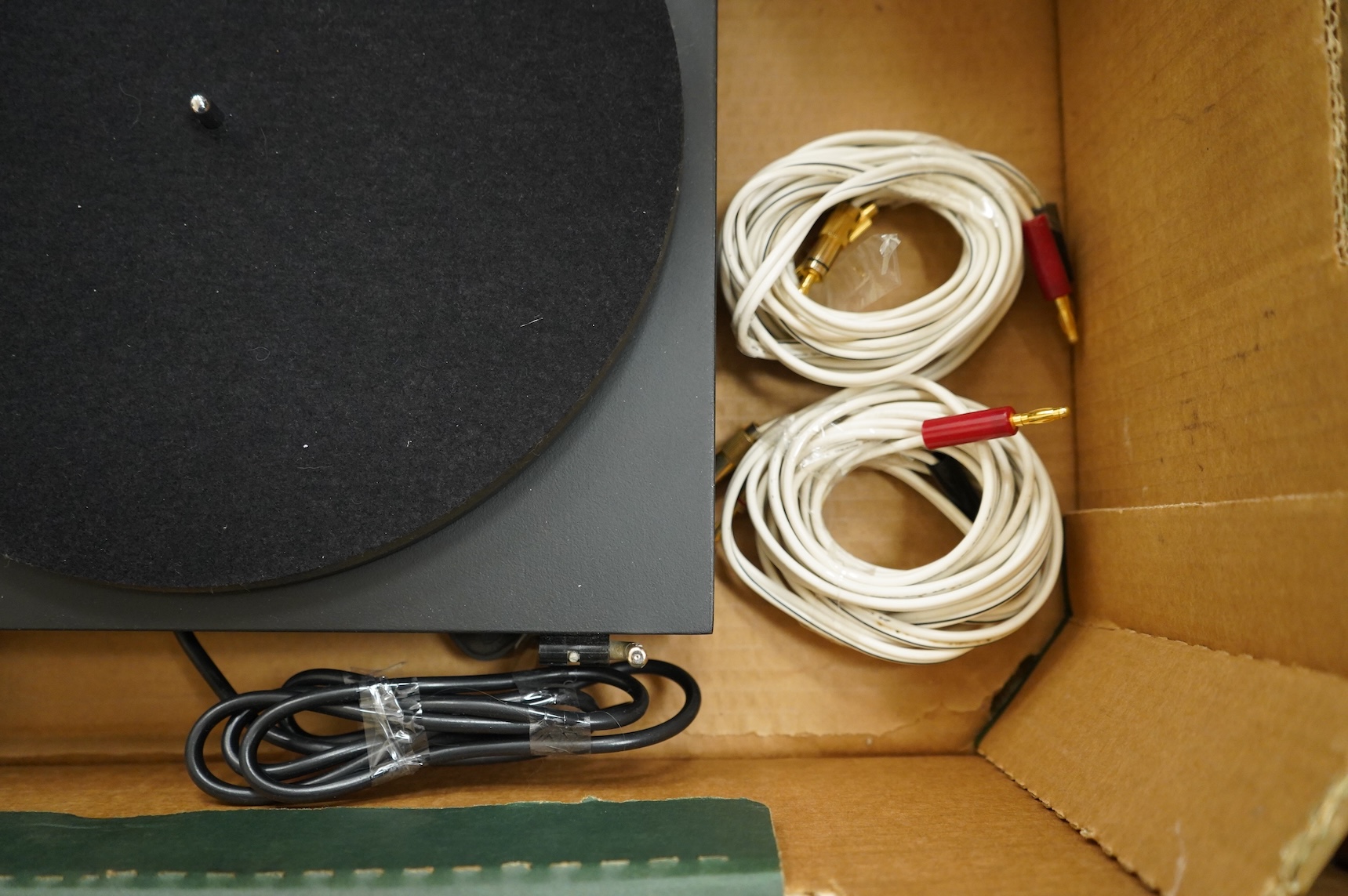 A collection of stereo equipment, including a Project P1 turntable record player, a Denon UPA-F10 integrated stereo amplifier with remote control, a boxed Kenwood KX-260 cassette tape player and a pair of Monitor Audio s